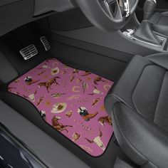 the interior of a car with a pink floor mat