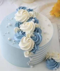 there is a blue and white cake on the table