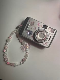 a camera and some beads on a table