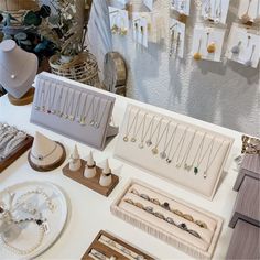 a table topped with lots of jewelry on display