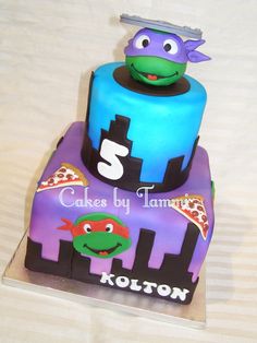 a three tiered cake is decorated with an image of a turtle and the number 3