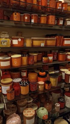 shelves filled with lots of different types of jars and containers on top of each other