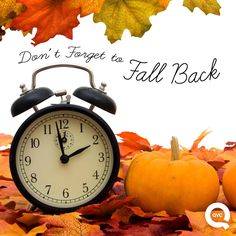 an alarm clock surrounded by fall leaves with the words don't forget to fall back