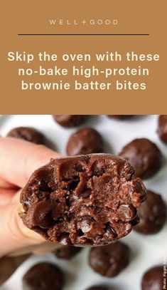 a hand holding a chocolate protein bar with the words, skip the oven with these no - bake high - protein brownie batter bites