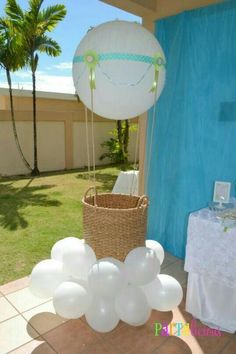 an air balloon and some white balloons on a table