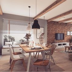 an open concept living and dining room with brick walls, wood flooring and exposed beams