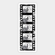 an old film strip with numbers and symbols in black and white stickers on it