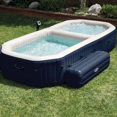 an inflatable hot tub sitting on the grass