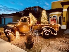 an old truck is decorated with christmas lights