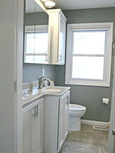 a bathroom with a sink, toilet and window