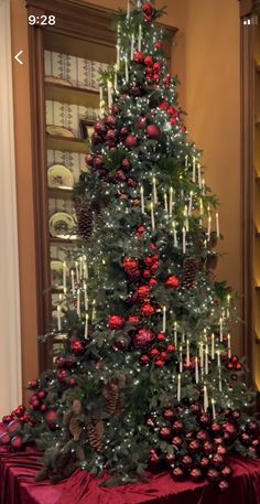 a decorated christmas tree with candles and ornaments