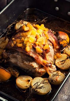 a roasting pan filled with meat and onions