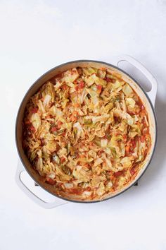 a large pot filled with food on top of a white table