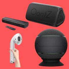 an assortment of electronic gadgets including a speaker, remote and other items on a red background