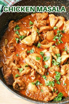 chicken masala in a skillet with parsley on top and the words chicken masala above it