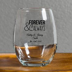 a wine glass with the words eat drink be married on it sitting on a wooden table