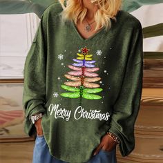 a woman wearing a green christmas tree sweater