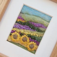 an art work with sunflowers and grass in the background, framed on white paper