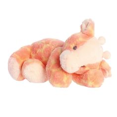 an orange and white stuffed animal laying on its side with it's eyes closed