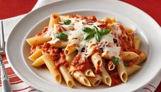 a white plate topped with pasta covered in sauce