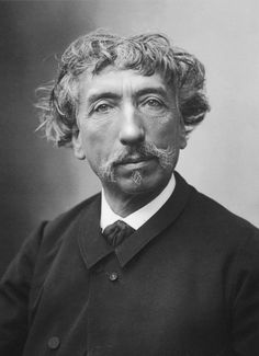 an old black and white photo of a man with curly hair