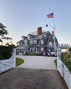 a large gray house with an american flag on top