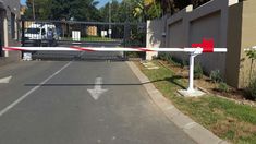 the road is blocked off by an orange and white barricade