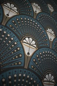 an art deco wallpaper design with fan shapes in gold and blue colors on a black background