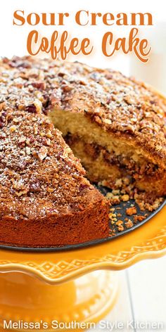 a cake on a yellow plate with the words sour cream coffee cake in front of it