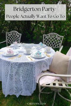 there is a table set for two with tea cups and saucers on the table