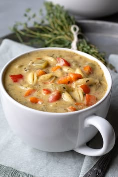 creamy vegetable noodle soup in a white bowl with text overlay that reads healthy vegan comfort food gluten free & nut - free options