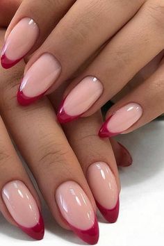 a woman's hands with red and pink nails