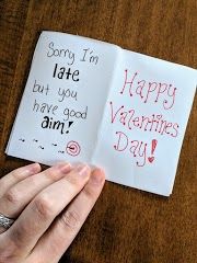 someone is writing on a valentine's day card