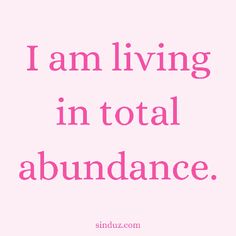 a pink background with the words i am living in total abundance, and an image of a