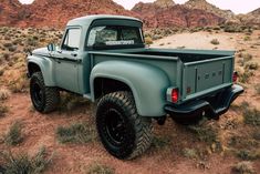 an old pick up truck parked in the desert