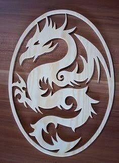 a wooden sign with a dragon carved into it's side on a wood wall