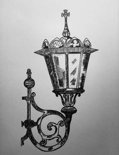 a black and white drawing of a street light on a pole with an ornate design