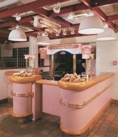 the interior of a restaurant with pink counters