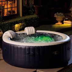 an inflatable hot tub sitting outside at night