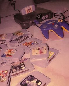 a pile of video game controllers sitting on top of a white table next to each other