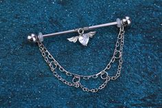 a metal barbell ring with a chain attached to it and a flower on the end