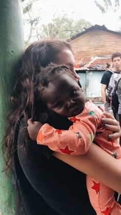 a woman holding a child in her arms