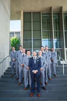 a group of men in suits and ties standing on steps