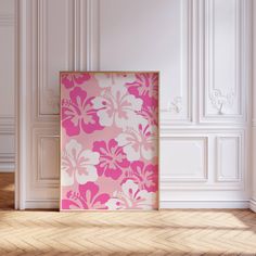 a pink and white floral print on a wall in an empty room with parquet flooring