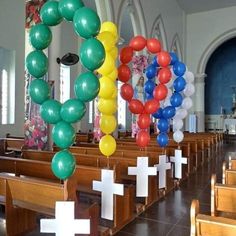 balloons and crosses decorate the pews in a church