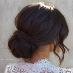 a woman with her hair in a low bun