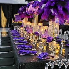 a long table is set with purple flowers and candles