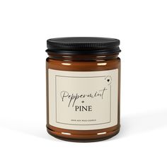 a jar of pepperoni and pine candle on a white background