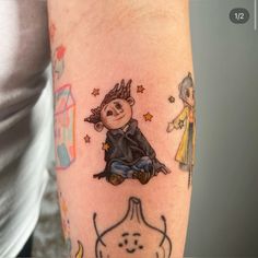 a person with a tattoo on their arm and the image of a cartoon character is shown