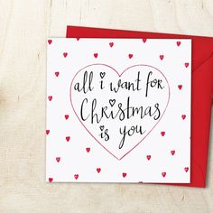 a card with the words all i want for christmas is you on it and hearts